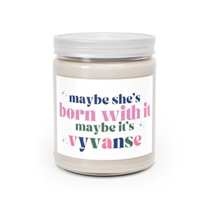 May include: A white candle jar with a label that reads "maybe she's born with it maybe it's vyvanse". The text is in a colourful font.