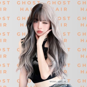 May include: A long, wavy wig with a split color design: black on one side and silver-gray on the other. The wig has bangs and is styled with loose curls. The background features the text "GHOST HAIR". The model size is 26 inches.