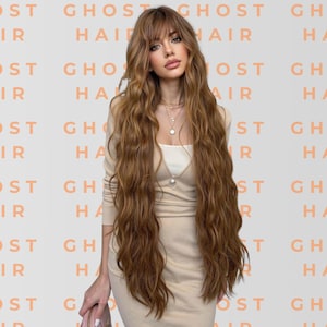 May include: A person with long, wavy, light brown hair, wearing a beige dress and a necklace. The background features the repeated text "GHOST HAIR" in a peach colour.