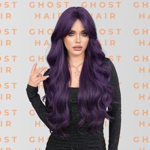 May include: A woman with long, wavy, purple hair. She is wearing a black long-sleeved top and a silver necklace. The background features the text "GHOST HAIR" in a repeating pattern.