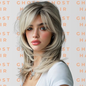 May include: A person with shoulder-length, layered platinum blonde hair featuring curtain bangs and dark roots. The background is a light gray surface with the repeating orange text GHOST HAIR. The person wears a white top and a silver chain necklace.