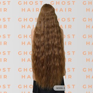 May include: A person with long, wavy, light brown hair, seen from behind. The hair falls down the back. The background has a repeating pattern of the words "GHOST HAIR". The text "MODEL S" is at the bottom.