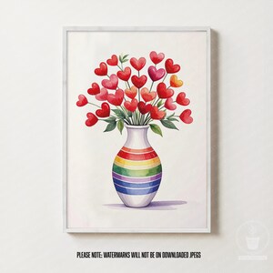 Può includere: Stampa artistica ad acquerello di un vaso con un design arcobaleno che tiene un bouquet di fiori rossi a forma di cuore. L'opera d'arte è incorniciata in un bordo bianco. L'immagine è un'opera d'arte romantica e colorata.