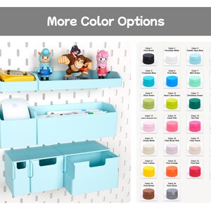 May include: A light blue pegboard storage system featuring a shelf with figurines, a rectangular bin holding a computer mouse and pens, and three drawers. A colour chart displays twenty-eight circular swatches labelled with names like Pure Black and Silver.