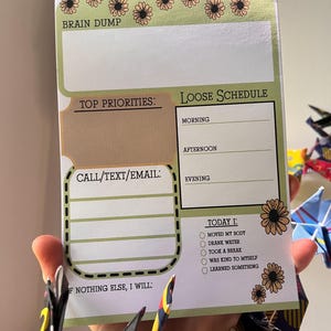 May include: ADHD daily planner with a green and tan floral design. The planner includes sections for a brain dump, top priorities, a loose schedule, and a checklist for daily tasks. The text "ADHD Daily Planner" is at the top.