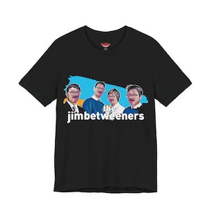 May include: Black t-shirt featuring a graphic of four men with glasses and the text "the jimbetweeners" in white. The graphic has a blue and yellow background. The shirt is a crew neck.