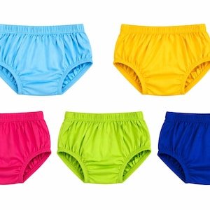 May include: Five pairs of baby underwear in various solid colors: light blue, yellow, hot pink, lime green, and royal blue. The underwear has a gathered waistband and leg openings.
