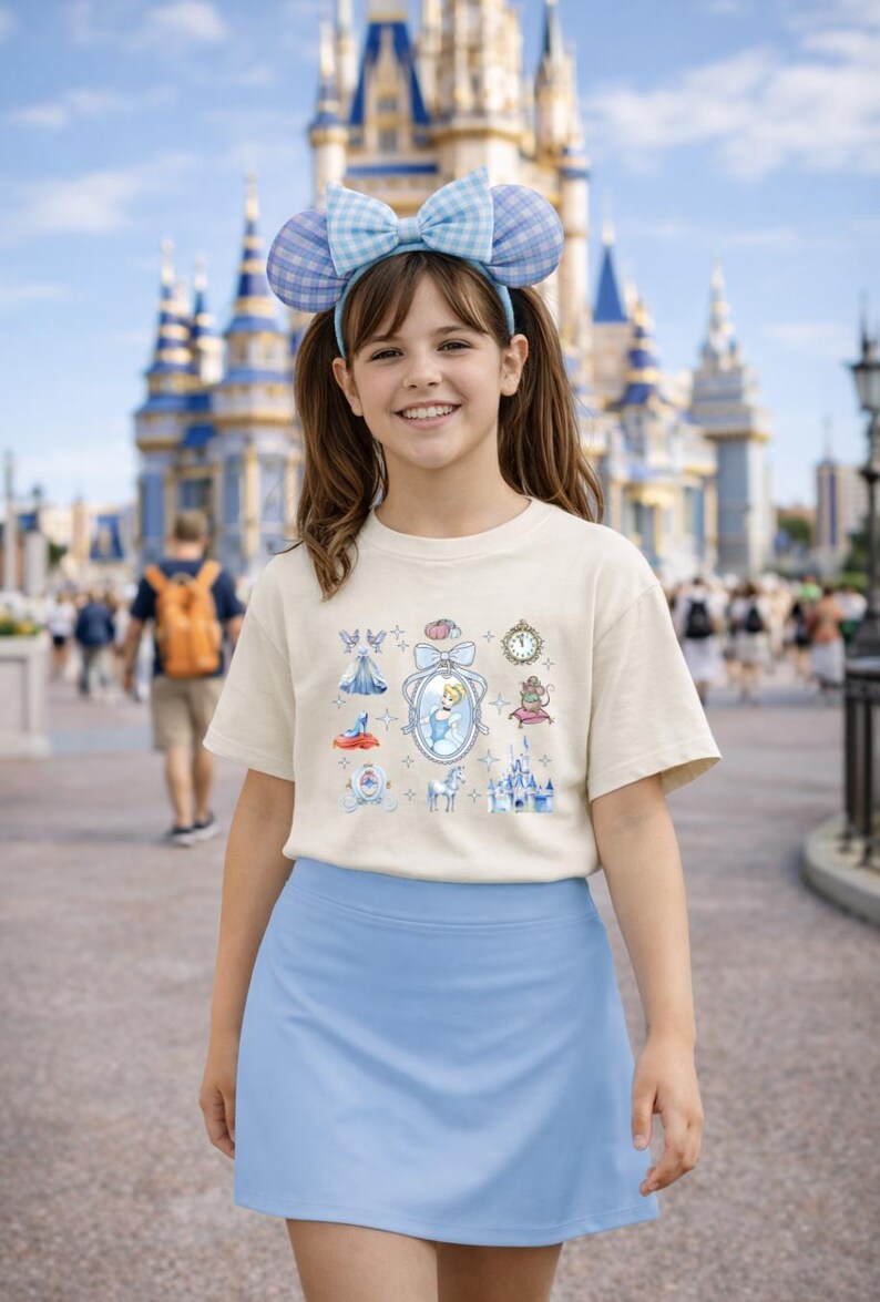 May include: A white ceramic mug with a black handle and the text "But First, Coffee" in a bold, black font. The mug is set against a blurred background, suggesting a cozy setting.
