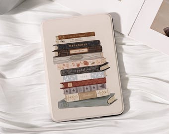 May include: A cream-colored e-reader case featuring a stack of books with titles like "Midnights" and "Folklore." The books are in various colors, including brown, blue, and red. The case has a rectangular shape and a smooth surface.