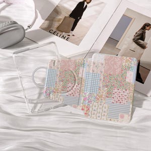 May include: A clear phone case and a patterned phone case with a floral patchwork design. The patchwork includes pink, blue, and white floral and gingham patterns. The phone case has a built-in ring holder.