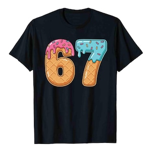May include: Black t-shirt featuring the number "67" designed to look like ice cream cones. The "6" is topped with pink frosting and the "7" with blue frosting, both with sprinkles. The numbers have a waffle cone texture.