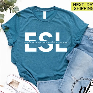 May include: Teal blue t-shirt with white text that reads "ESL" and "english as a second language".