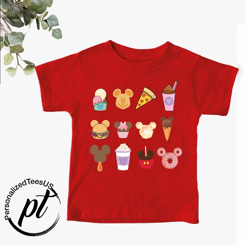 May include: Red short-sleeved t-shirt with a Mickey Mouse design featuring various Disney food items, including ice cream, pizza, cupcakes, and donuts.