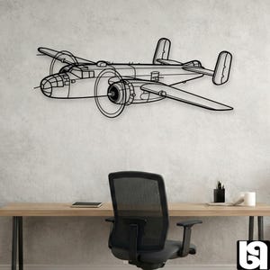 May include: Black metal wall art of a vintage airplane, featuring detailed outlines of the fuselage, wings, and propellers. The artwork is mounted on a light gray wall above a desk and office chair, creating a modern industrial aesthetic.