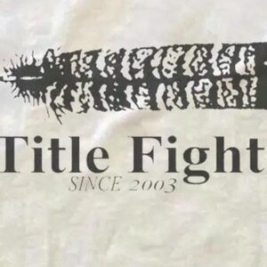 May include: A white background with a black feather design and the words "Title Fight" and "Since 2003" in a serif font. The feather is stylized and textured.