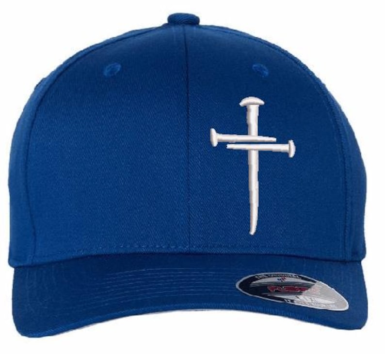 May include: A blue baseball cap with a white embroidered cross design. The cap has a curved brim and a Flexfit tag. The cap is made of a durable fabric and has a structured fit.