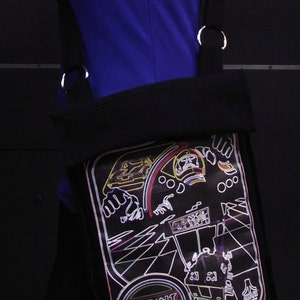 May include: Black canvas bag with a neon graphic of a video game character and the text "SPRINT 8".