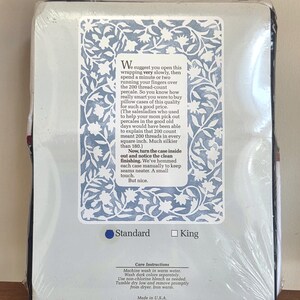May include: A packaged pillowcase set with a light blue and white floral design. The packaging includes text describing the percale fabric and care instructions. The set is available in standard and king sizes.