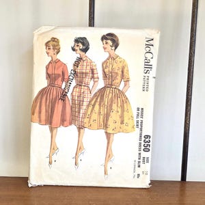 May include: Vintage McCall's printed sewing pattern with illustrations of three dresses. The pattern packet shows a size 10, bust 79 cm, and includes instructions for a slim or full skirt. The cover has the text "NOT EXCHANGABLE".
