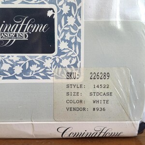 May include: A packaged white pillowcase from Coming Home with Lands' End. The packaging features a blue and white floral design and the brand name. A sticker displays the SKU, style, size, color, and vendor information.