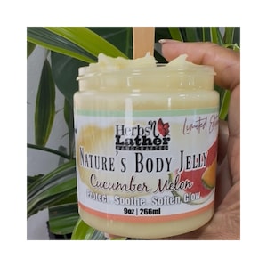 May include: A jar of "Nature's Body Jelly" with a cucumber melon scent. The label reads "Herbs & Lather, Handcrafted." The jar contains a light yellow jelly and is 9 oz (266ml).