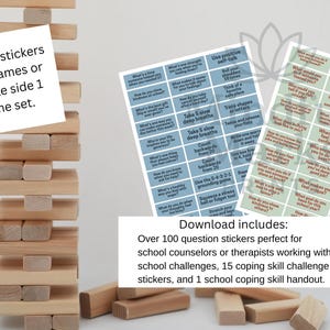 May include: A wooden block stacking game with a tower of blocks and two sheets of stickers. The stickers have questions and coping skill prompts. The text says "Enough stickers for 2 games or double side 1 game set."