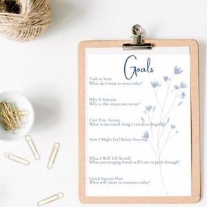 May include: A printable worksheet with a blue floral design and the word "Goals" in blue text. The worksheet includes prompts to help you set goals, such as "Task to Start", "Why It Matters", "First Tiny Action", "How I Might Feel Before Starting", "What I Will Tell Myself", and "Quick Success Plan".