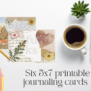 May include: Arrangement of six 5x7 inch printable journaling cards with vintage collage elements, including dried flowers, butterflies, and handwritten script. A cup of coffee, a succulent, a notepad, and colored pencils are also present.
