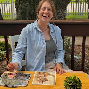 this is a picture of the artist, Bri, painting outside
