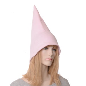 May include: A pink fleece gnome hat with a pointed top. The hat is worn on a mannequin with long blonde hair.