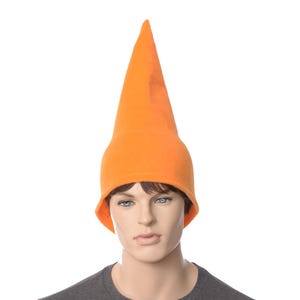 May include: A tall, orange, pointed hat made of felt. The hat is worn by a person with a neutral expression.