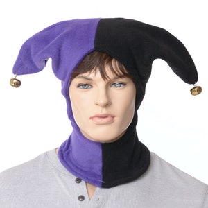 May include: A purple and black jester hat with bells on the ends of the points. The hat has a matching neck warmer.