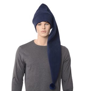 May include: A navy blue fleece hat with a long, pointed tip and a small pom-pom at the end. The hat is worn by a mannequin wearing a gray long-sleeved shirt. The hat is designed to be worn as sleepwear.