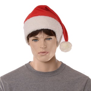 May include: A red and white Santa hat with a white pom-pom on top. The hat is made of soft, plush fabric.