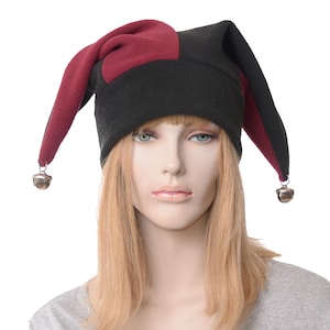 May include: A black and burgundy fleece jester hat with bells on the ends of the points.