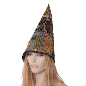 May include: A pointed, cone-shaped hat with a patchwork design of black, orange, green, and blue fabric. The hat has a black band around the bottom.