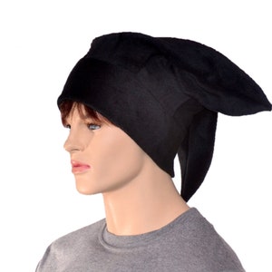May include: A black hat with a unique, elongated design. The hat is made of a soft, dark fabric and features a pointed shape extending from the sides. The hat is worn by a mannequin.