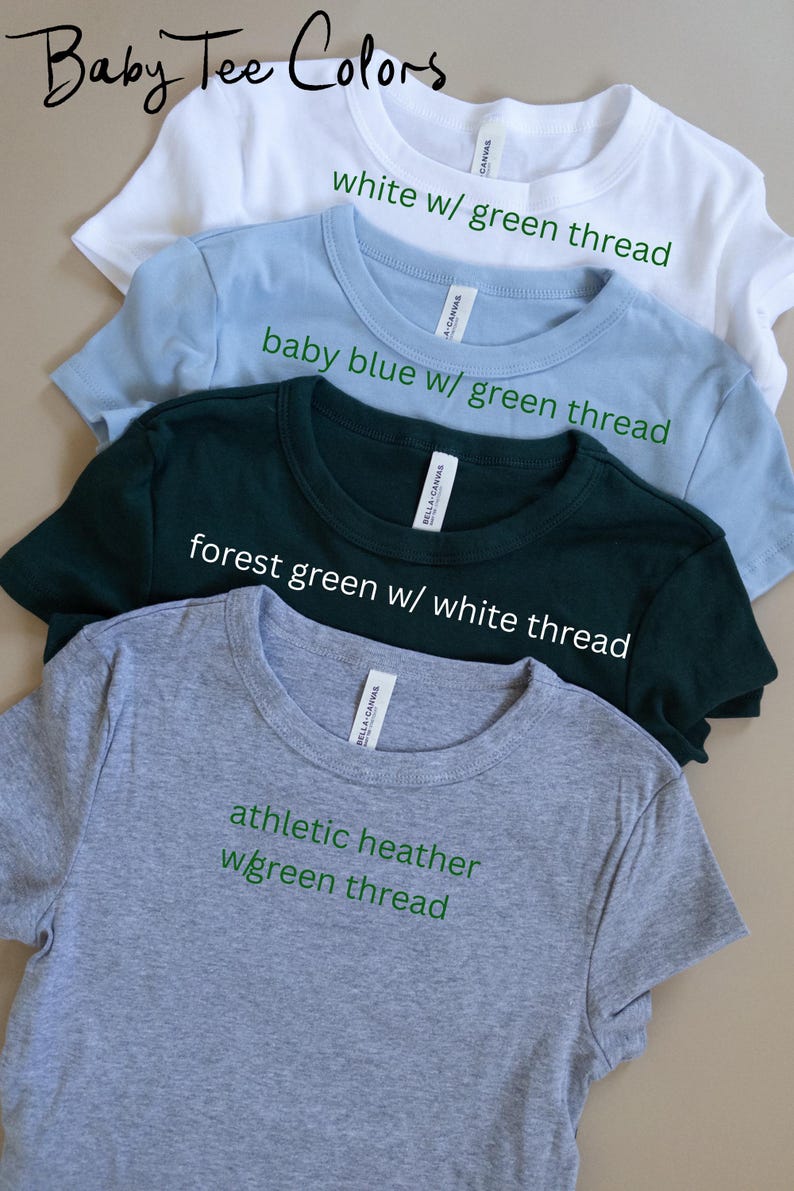 a collection of four t-shirts, each with a different color and thread pattern, arranged in a row.