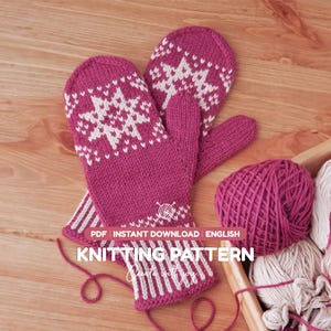 May include: A pair of magenta and white knitted mittens featuring a snowflake pattern on the back of the hand and a striped cuff. The image includes a ball of magenta yarn and text that reads: PDF INSTANT DOWNLOAD ENGLISH KNITTING PATTERN.