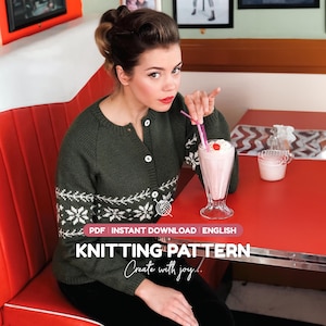 May include: A dark olive green long-sleeved cardigan featuring a white snowflake and branch pattern across the chest and sleeves, with white buttons. The image includes text: PDF INSTANT DOWNLOAD ENGLISH KNITTING PATTERN Create with joy.