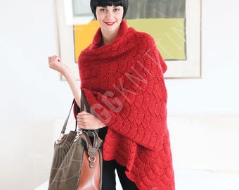 May include: A vibrant red knitted shawl featuring a textured fan-like pattern draped over the shoulders. The shawl has a high collar and a scalloped edge. Accompanying the shawl is a structured handbag with a dark olive green fabric body and brown leather trim, featuring gold-toned metal hardware and dual handles.