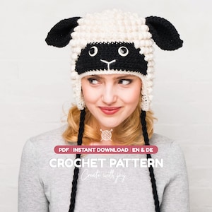 May include: A crochet hat designed to look like a sheep, featuring a textured cream-colored body, black ears, and a black face with white eyes and a stitched nose. The hat includes long black braided ties and text reading PDF INSTANT DOWNLOAD.