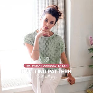 May include: A light green short-sleeved knit top with a vertical openwork stitch pattern, a round neckline, and ribbed trim. The image includes text that reads: PDF INSTANT DOWNLOAD EN & FR KNITTING PATTERN Create with joy.