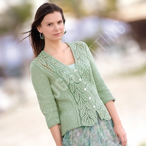 May include: A pale green knitted cardigan with a V-neck and three-quarter sleeves. The cardigan has a button-up front and decorative leaf patterns. The model is wearing a light blue top underneath.