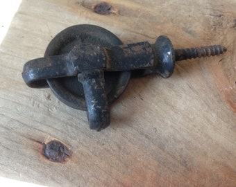 vintage small iron wheel pulley with ceiling screw attachment barn use