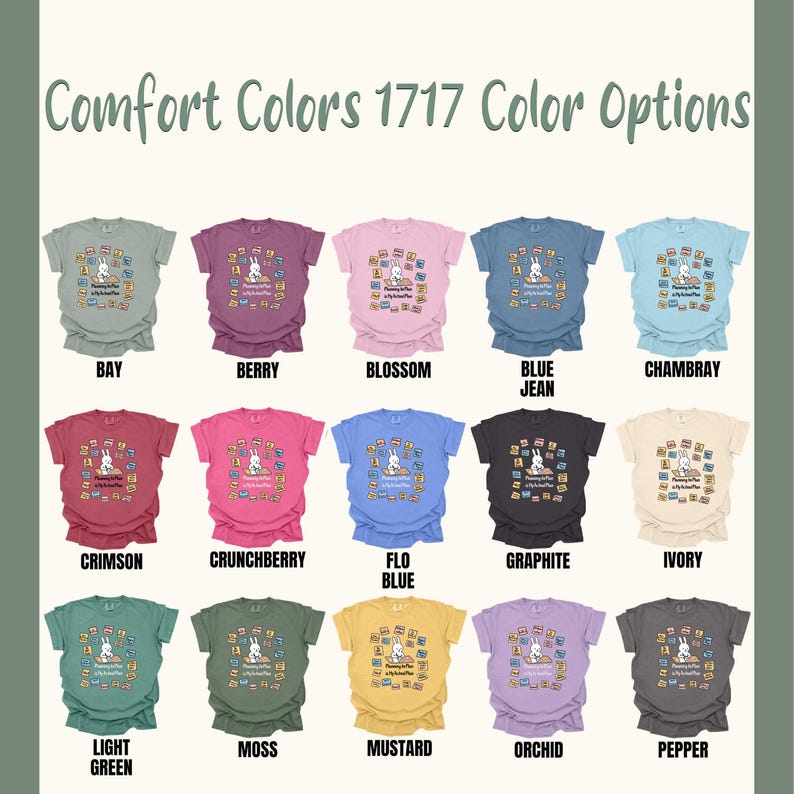May include: A display of Comfort Colors t-shirts in various colors, including Bay, Berry, Blossom, and Blue Jean. Each shirt features a graphic of a bunny reading books. The text "Comfort Colors 1717 Color Options" is at the top.