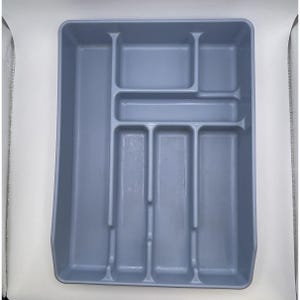 May include: A light blue plastic utensil tray with multiple compartments. The tray is rectangular with a series of dividers creating various sections for organizing silverware and kitchen tools. The design is simple and functional.