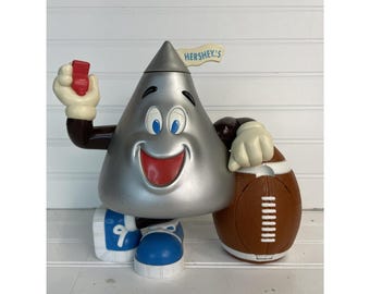 Dispensador de dulces Hershey Kiss de árbitro de fútbol, modelo vintage de 1999, con parte superior giratoria y movimiento interior.
