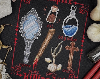 May include: A black and red cross stitch pattern with the text "Vampire Killing Kit" and images of a mirror, stake, garlic, holy water, and a crucifix.