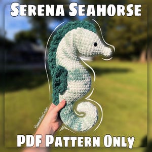 May include: A crocheted seahorse in white, teal, and green. The seahorse has a textured appearance and is held by a hand. The text "Serena Seahorse" and "PDF Pattern Only" are displayed.